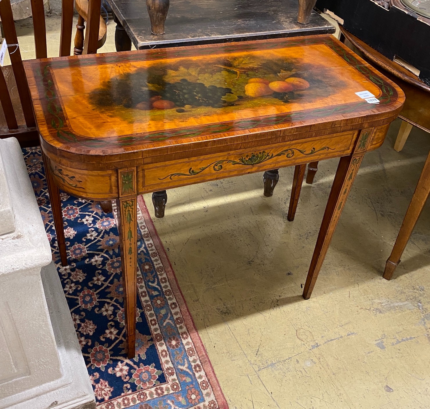 A George III banded satinwood folding card table with later painted decoration, width 92cm, depth 45cm, height 74cm